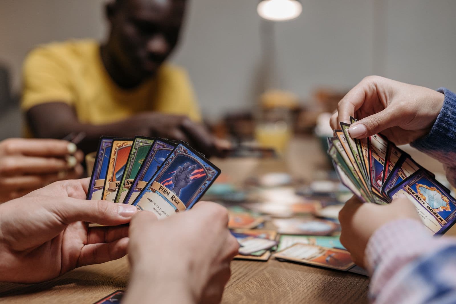 Adults playing a card game together around a table indoors — illustrative demo image