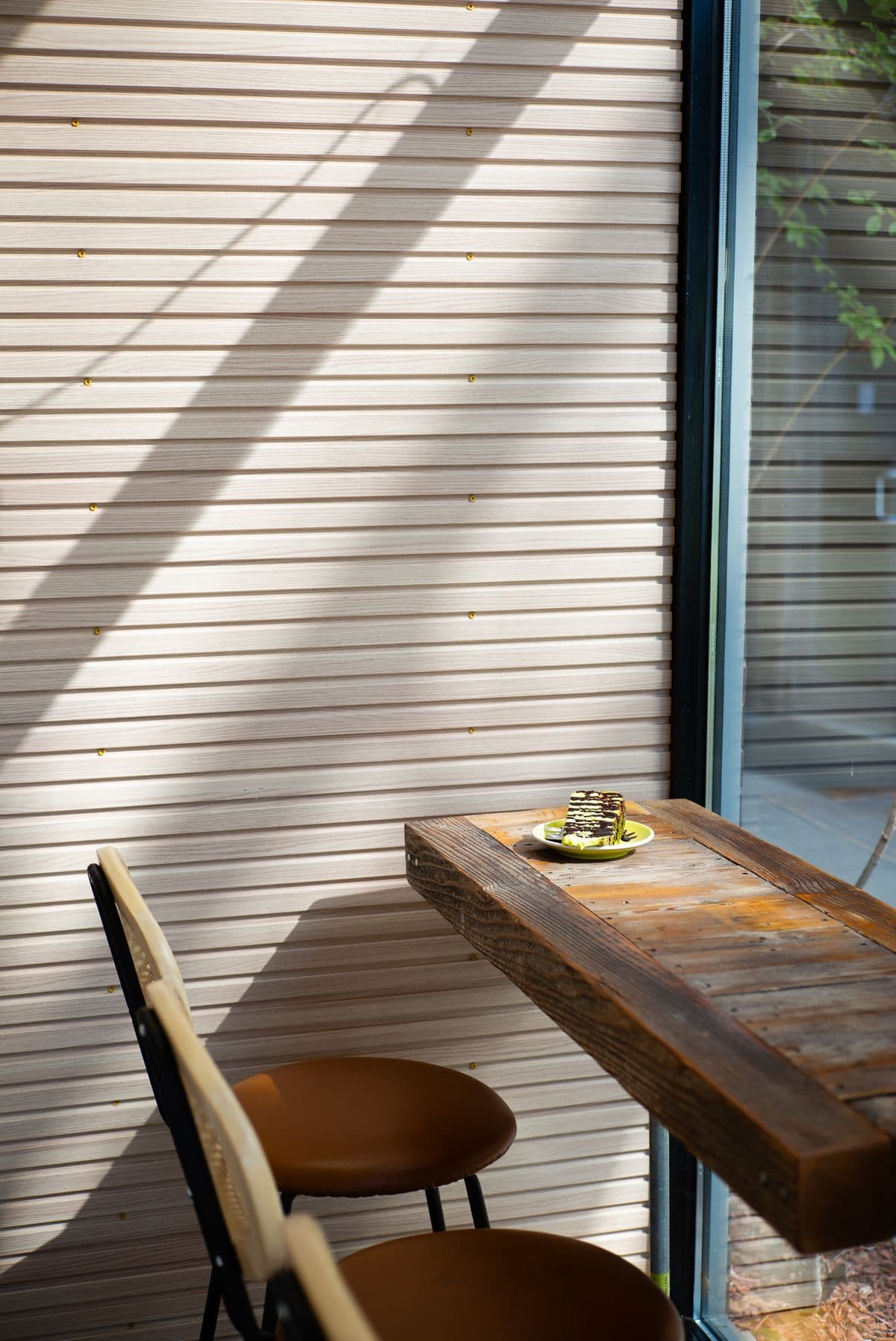 A quiet corner with a sunlit wooden table and chairs — illustrative demo image